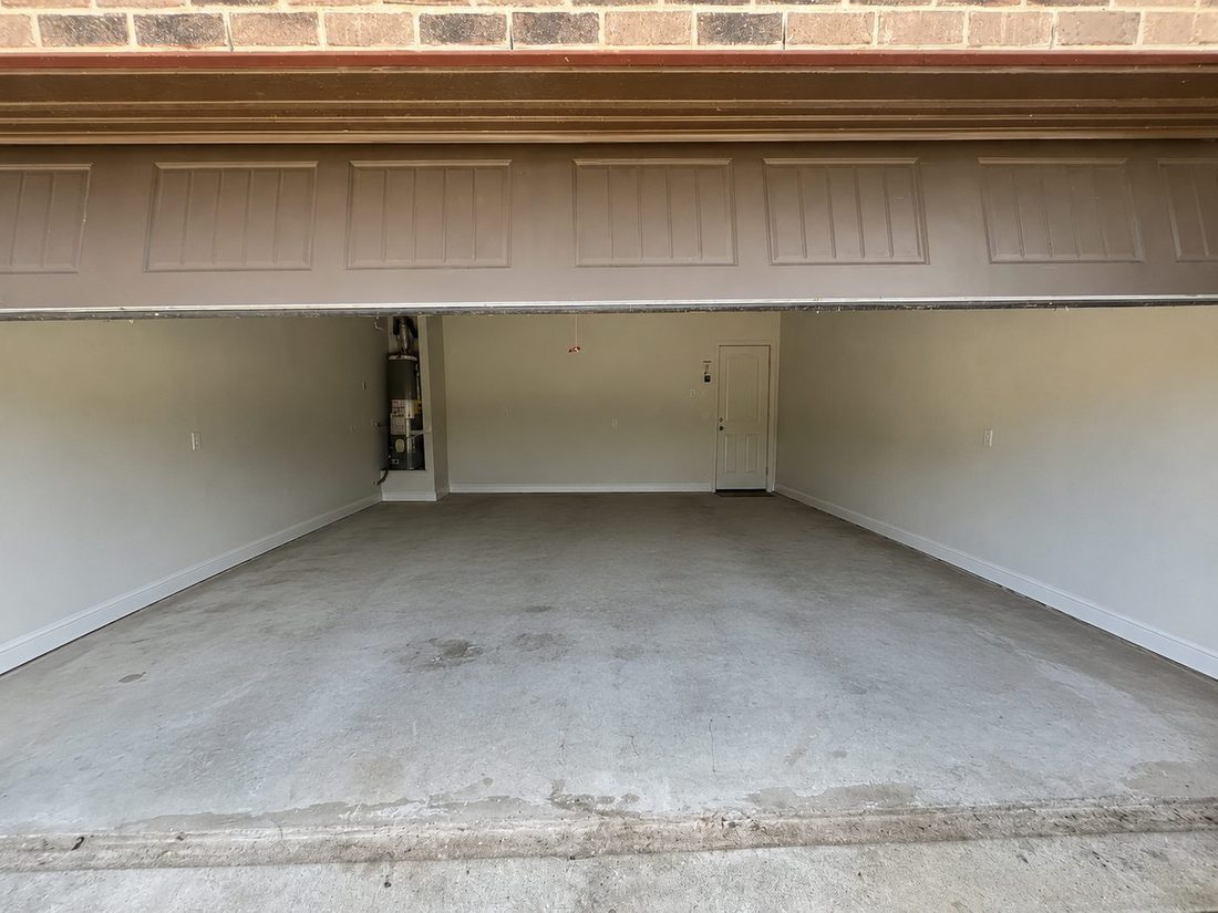 After: the same garage fully cleared out and swept clean