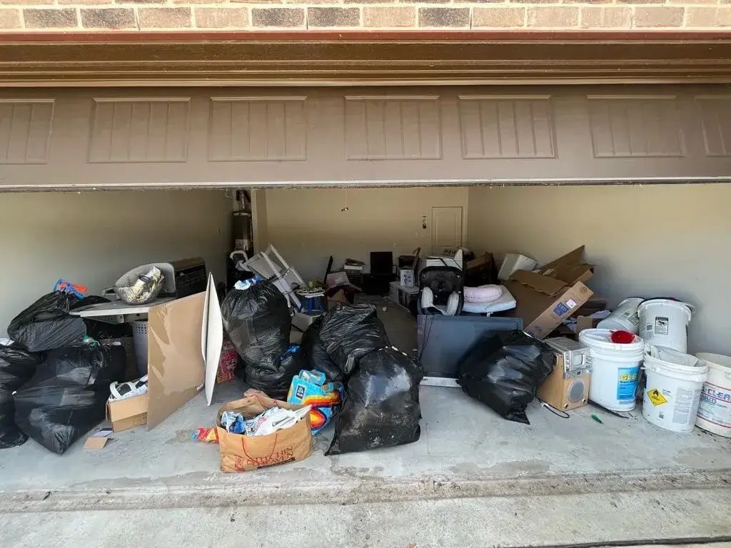 Before: an Albany, Oregon garage packed with boxes, bags, buckets and household junk