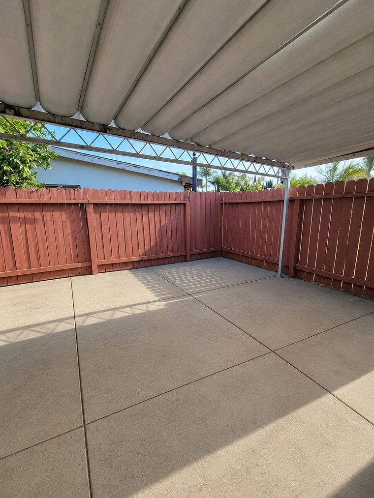 After: the same patio cleared of everything and swept clean